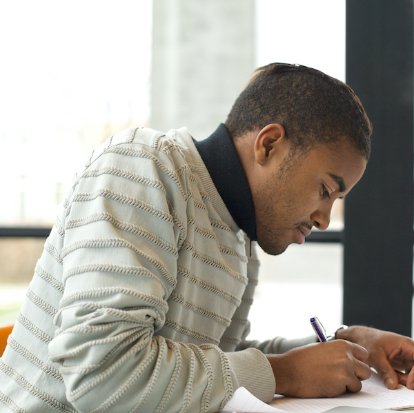 A student veteran concentrates on filling in the Veteran’s Career Planner Workbook